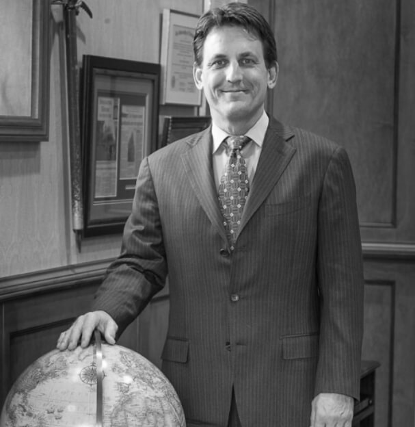 Headshot of Gerard Keating with a globe.